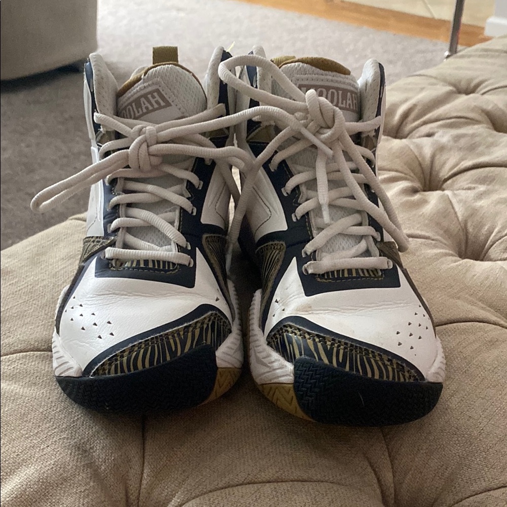 Stylish White and Black Sneakers with Gold Accents